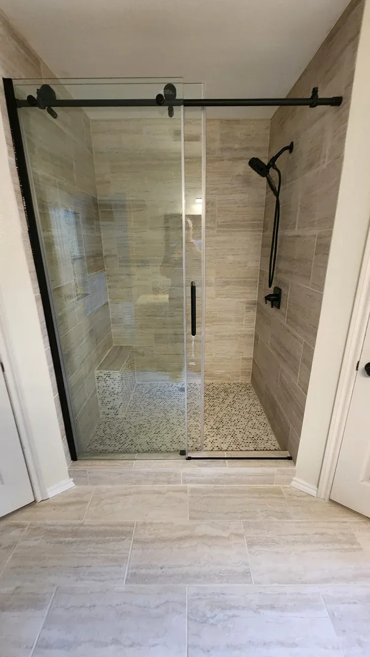 Commerce Bathroom frameless glass shower enclosure and tiling detail
